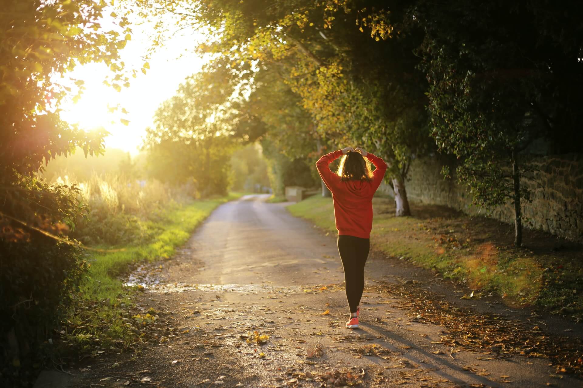 A woman running on a wooded path.